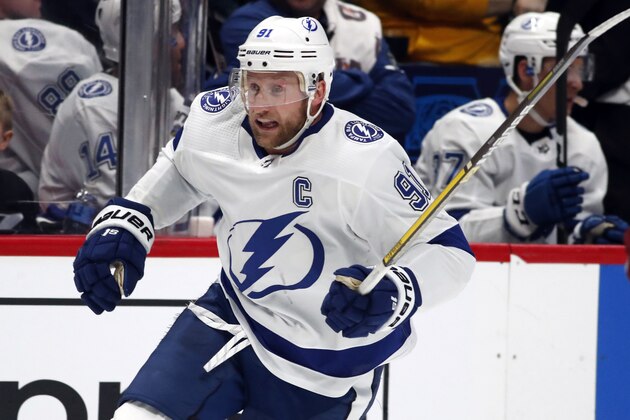 FILE - In this Feb. 17, 2020, file photo, Tampa Bay Lightning center Steven Stamkos (91) skates during the second period of an NHL hockey game in Denver. Columbus defenseman Seth Jones, Pittsburgh forward Jake Guentzel and Tampa Bay captain Steven Stamkos would’ve missed some or all of the playoffs if they started in April. Instead, the silver lining of the COVID-19 pandemic halting the season is those players are healthy and ready to contribute. (AP Photo/David Zalubowski, File) FILE - In this Feb. 17, 2020, file photo, Tampa Bay Lightning center Steven Stamkos (91) skates during the second period of an NHL hockey game in Denver. Columbus defenseman Seth Jones, Pittsburgh forward Jake Guentzel and Tampa Bay captain Steven Stamkos would’ve missed some or all of the playoffs if they started in April. Instead, the silver lining of the COVID-19 pandemic halting the season is those players are healthy and ready to contribute. (AP Photo/David Zalubowski, File)