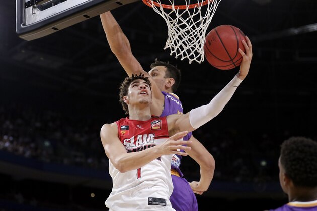 LaMelo Ball of the Illawarra Hawks, left, lays up around Andrew Bogut of the Sydney Kings during their game in the Australian Basketball League in Sydney, Sunday, Nov. 17, 2019. (AP Photo/Rick Rycroft) LaMelo Ball of the Illawarra Hawks, left, lays up around Andrew Bogut of the Sydney Kings during their game in the Australian Basketball League in Sydney, Sunday, Nov. 17, 2019. (AP Photo/Rick Rycroft)