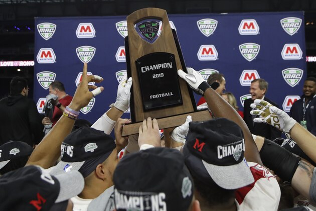 Members of the Miami of Ohio team hold the champion trophy after the Mid-American Conference championship NCAA college football game against Central Michigan, Saturday, Dec. 7, 2019, in Detroit. (AP Photo/Carlos Osorio)