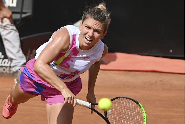 Romania's Simona Halep returns the ball to Spain's Garbine Muguruza during their semifinal at the Italian Open tennis tournament, in Rome, Sunday, Sept. 20, 2020. (Alfredo Falcone/LaPresse via AP)