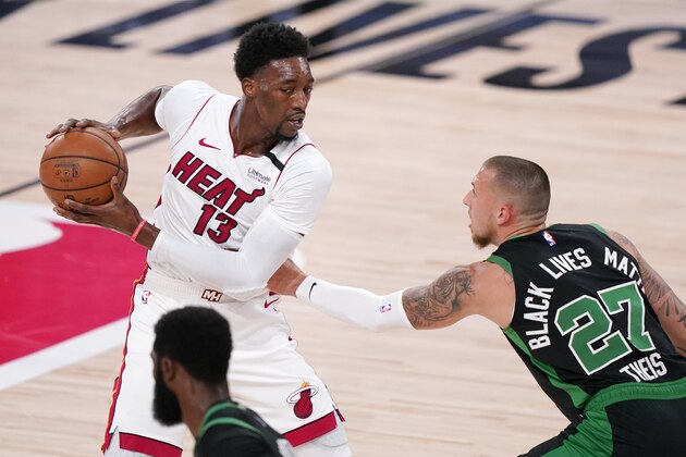 Miami Heat's Bam Adebayo (13) is defended by Boston Celtics' Daniel Theis (27) during the first half of an NBA conference final playoff basketball game Friday, Sept. 25, 2020, in Lake Buena Vista, Fla. (AP Photo/Mark J. Terrill)