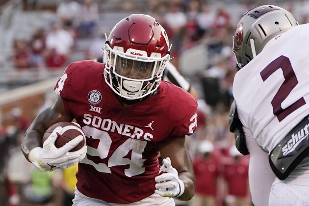 Oklahoma running back Marcus Major (24) carries against Missouri State defender Isaiah Sayles (2) in the second half of an NCAA college football game Saturday, Sept. 12, 2020, in Norman, Okla. (AP Photo/Sue Ogrocki)