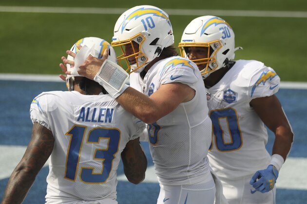 Los Angeles Chargers quarterback Justin Herbert (10) celebrates after a touchdown with Los Angeles Chargers wide receiver Keenan Allen (13) and Los Angeles Chargers running back Austin Ekeler (30) during an NFL football game between the between the Kansas City Chiefs and the Los Angeles Chargers, Sunday, Sept. 20, 2020, in Inglewood, Calif. (AP Photo/Peter Joneleit)