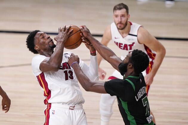 Miami Heat's Bam Adebayo (13) and Boston Celtics' Jaylen Brown (7) battle for the ball during the second half of an NBA conference final playoff basketball game Friday, Sept. 25, 2020, in Lake Buena Vista, Fla. (AP Photo/Mark J. Terrill)