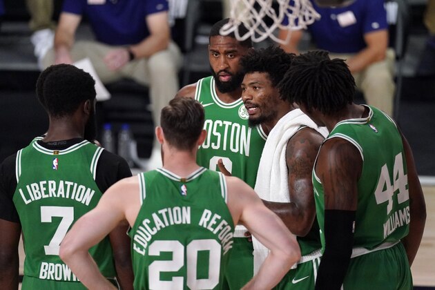 Boston Celtics' Jaylen Brown (7), Gordon Hayward (20), Robert Williams III (44) and Brad Wanamaker, rear, listen as Marcus Smart, second from right, talks to them in a huddle during the first half of Game 4 of an NBA basketball Eastern Conference final against the Miami Heat on Wednesday, Sept. 23, 2020, in Lake Buena Vista, Fla. (AP Photo/Mark J. Terrill)