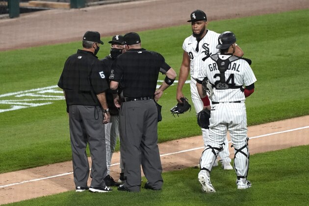 Chicago White Sox manager Rick Renteria, second from left, argues with umpires as catcher Yasmani Grandal, right, and relief pitcher Jimmy Cordero react during the seventh inning of a baseball game against the Chicago Cubs in Chicago, Friday, Sept. 25, 2020. Cordero ejected by home plate umpire Dan Bellino. (AP Photo/Nam Y. Huh) Chicago White Sox manager Rick Renteria, second from left, argues with umpires as catcher Yasmani Grandal, right, and relief pitcher Jimmy Cordero react during the seventh inning of a baseball game against the Chicago Cubs in Chicago, Friday, Sept. 25, 2020. Cordero ejected by home plate umpire Dan Bellino. (AP Photo/Nam Y. Huh)