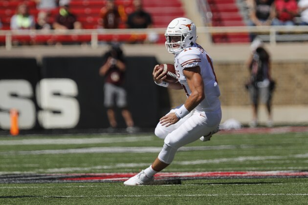 Texas quarterback Sam Ehlinger carries the ball during the first half of an NCAA college football game against Texas Tech, Saturday Sept. 26, 2020, in Lubbock, Texas. (AP Photo/Mark Rogers)