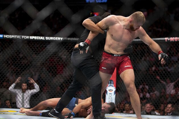 Jan Blachowicz, right, reacts after knocking out Luke Rockhold during the second round of their light heavyweight mixed martial arts bout at UFC 239, Saturday, July 6, 2019, in Las Vegas. (AP Photo/Eric Jamison)
