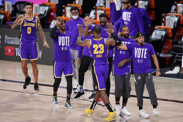 Los Angeles Lakers' LeBron James (23) celebrates with teammates during a timeout in the final moments of an NBA conference final playoff basketball game against the Denver Nuggets Saturday, Sept. 26, 2020, in Lake Buena Vista, Fla. The Lakers won 117-107 to win the series 4-1. (AP Photo/Mark J. Terrill) Los Angeles Lakers' LeBron James (23) celebrates with teammates during a timeout in the final moments of an NBA conference final playoff basketball game against the Denver Nuggets Saturday, Sept. 26, 2020, in Lake Buena Vista, Fla. The Lakers won 117-107 to win the series 4-1. (AP Photo/Mark J. Terrill)