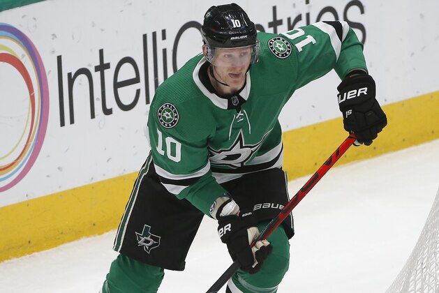 Dallas Stars right wing Corey Perry (10) moves the puck behind Nashville Predators goaltender Juuse Saros (74) during the first period of an NHL hockey game Saturday, March 7, 2020, in Dallas. (AP Photo/Ron Jenkins)