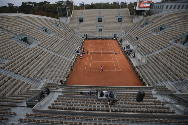 Suzanne Lenglen court is near-empty as Victoria Azarenka of Belarus plays in the first round match of the French Open tennis tournament against Montenegro's Danka Kovinic at the Roland Garros stadium in ParisParis, France, Sunday, Sept. 27, 2020. (AP Photo/Alessandra Tarantino)