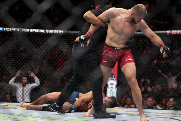 Jan Blachowicz, right, reacts after knocking out Luke Rockhold during the second round of their light heavyweight mixed martial arts bout at UFC 239, Saturday, July 6, 2019, in Las Vegas. (AP Photo/Eric Jamison)