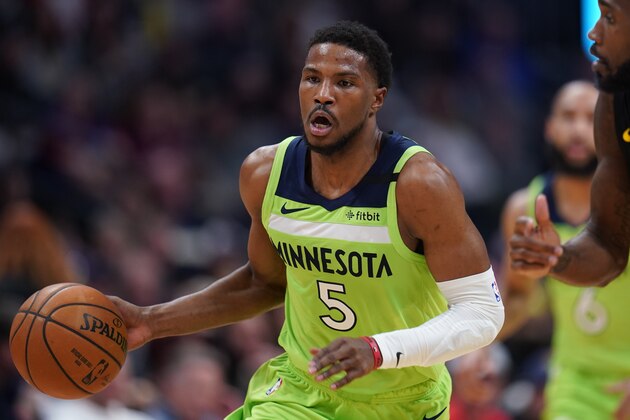 Minnesota Timberwolves guard Malik Beasley moves the ball up court during an NBA basketball game between the Denver Nuggets and the Minnesota Timberwolves Sunday, Feb. 23, 2020, in Denver. (AP Photo/Jack Dempsey)