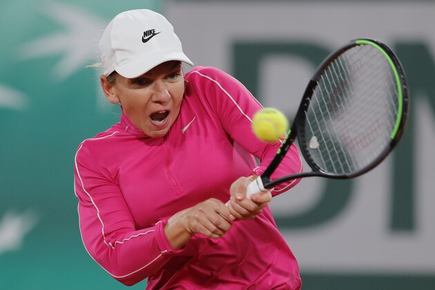 Romania's Simona Halep plays a shot against Spain's Sara Sorribes Tormo in the first round match of the French Open tennis tournament at the Roland Garros stadium in Paris, France, Sunday, Sept. 27, 2020. (AP Photo/Christophe Ena)