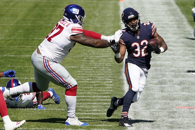 New York Giants defensive tackle Dexter Lawrence (97) pushes Chicago Bears running back David Montgomery (32) out of bounds during the first half of an NFL football game in Chicago, Sunday, Sept. 20, 2020. (AP Photo/Charles Rex Arbogast)
