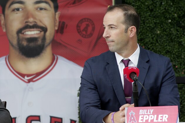 Los Angeles Angels team owner Arte Moreno, left, talks with general manager Billy Eppler, right, to introduce the newest Angels baseball player Anthony Rendon during a news conference in Anaheim, Calif., Saturday, Dec. 14, 2019. Rendon and the Los Angeles Angels agreed to a $245 million, seven-year contract earlier in the week. (AP Photo/Alex Gallardo)