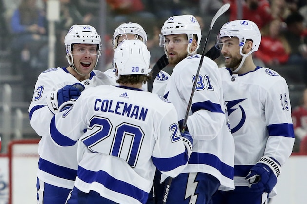 Tampa Bay Lightning center Carter Verhaeghe, left, celebrates with center Blake Coleman (20), defenseman Erik Cernak (81) and Barclay Goodrow after scoring against the Detroit Red Wings during the second period of an NHL hockey game Sunday, March 8, 2020, in Detroit. (AP Photo/Duane Burleson)