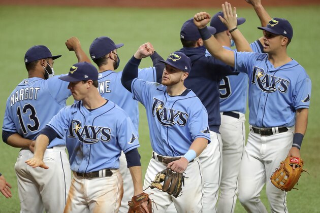 Members of the Tampa Bay Rays celebrate a 5-0 win over the Philadelphia Phillies in a baseball game Sunday, Sept. 27, 2020, in St. Petersburg, Fla. (AP Photo/Mike Carlson) Members of the Tampa Bay Rays celebrate a 5-0 win over the Philadelphia Phillies in a baseball game Sunday, Sept. 27, 2020, in St. Petersburg, Fla. (AP Photo/Mike Carlson)