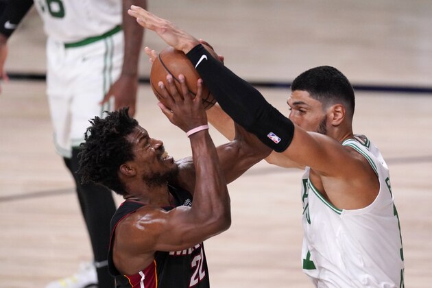Miami Heat's Jimmy Butler (22) takes a shot as Boston Celtics' Enes Kanter (11) blocks during the first half of an NBA conference final playoff basketball game Sunday, Sept. 27, 2020, in Lake Buena Vista, Fla. (AP Photo/Mark J. Terrill)