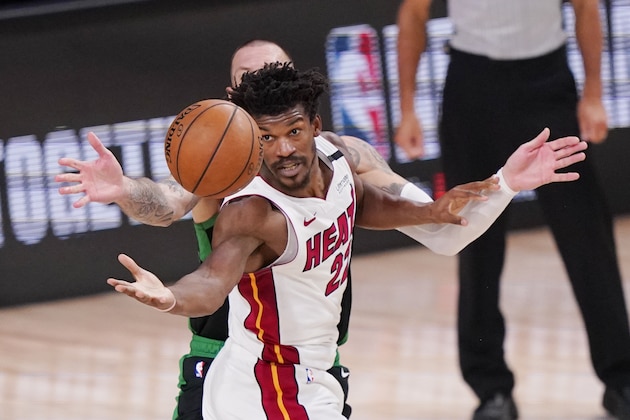 Miami Heat's Jimmy Butler (22) reaches for the ball during the second half of an NBA conference final playoff basketball game against the Boston Celtics Friday, Sept. 25, 2020, in Lake Buena Vista, Fla. The Celtics won 121-108. (AP Photo/Mark J. Terrill)