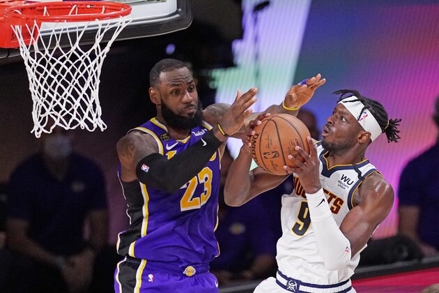 Denver Nuggets' Jerami Grant (9) drives against Los Angeles Lakers' LeBron James (23) during the second half of an NBA conference final playoff basketball game Saturday, Sept. 26, 2020, in Lake Buena Vista, Fla. (AP Photo/Mark J. Terrill)