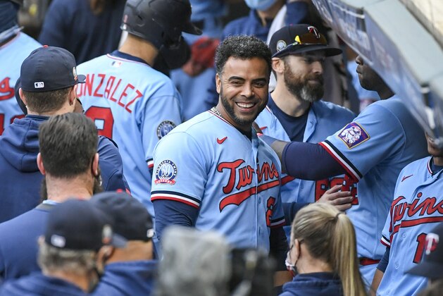 Minnesota Twins Minnesota Twins Nelson Cruz, center, smiles in the dugout after the Twins clinched the AL Central championship with the Chicago White Sox's loss during the tenth inning of a baseball game Sunday, Sept. 27, 2020, in Minneapolis. The Reds won 5-3. (AP Photo/Craig Lassig)