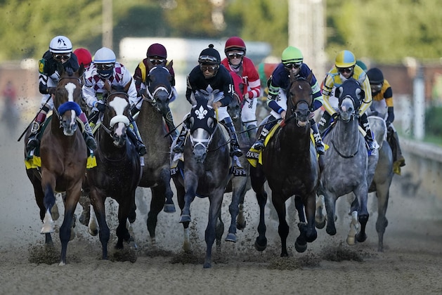 John Velazquez rides Authentic, left, as they head to turn one in the 146th running of the Kentucky Derby horse race at Churchill Downs, Saturday, Sept. 5, 2020, in Louisville, Ky. (AP Photo/Mark Humphrey)