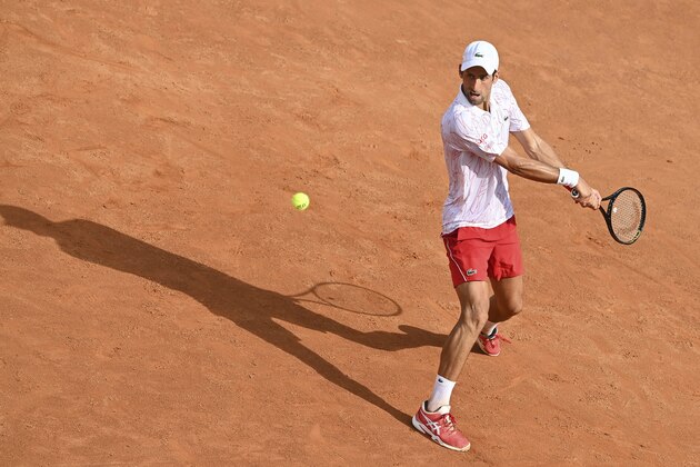 Serbia's Novak Djokovic returns the ball to Germany's Dominik Koepfer during their quarterfinal match at the Italian Open tennis tournament, in Rome, Saturday, Sept. 19, 2020. (Alfredo Falcone/LaPresse via AP)