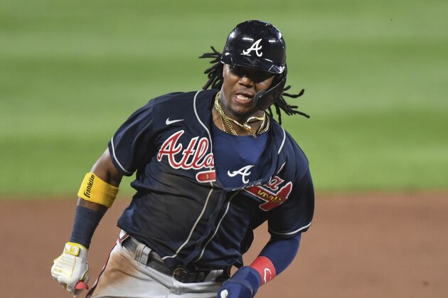 Atlanta Braves center fielder Ronald Acuna Jr. (13) scores run during the ninth inning of a baseball game against the Baltimore Orioles, Tuesday, Sept. 15, 2020, in Baltimore. (AP Photo/Terrance Williams)