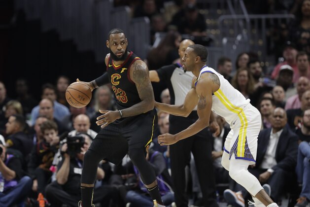 Golden State Warriors forward Andre Iguodala (9) defends Cleveland Cavaliers forward LeBron James (23) in the first half of Game 3 of basketball's NBA Finals, Wednesday, June 6, 2018, in Cleveland. (AP Photo/Tony Dejak)