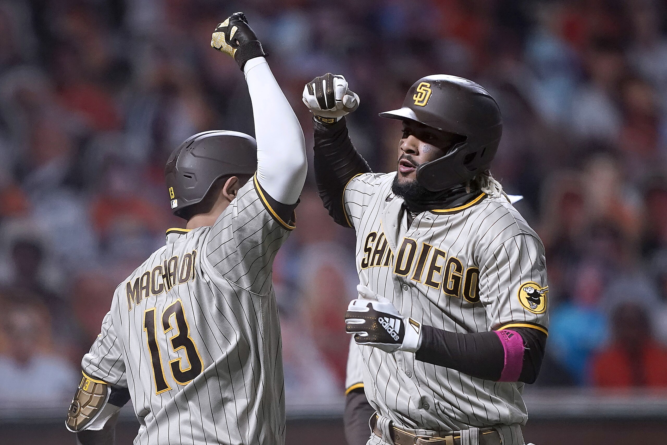 San Diego Padres' Fernando Tatis Jr. is congratulated by Manny Machado (13) after hitting two-run home run against the San Francisco Giants during the third inning of the second game of a baseball doubleheader Friday, Sept. 25, 2020, in San Francisco. (AP Photo/Tony Avelar) San Diego Padres' Fernando Tatis Jr. is congratulated by Manny Machado (13) after hitting two-run home run against the San Francisco Giants during the third inning of the second game of a baseball doubleheader Friday, Sept. 25, 2020, in San Francisco. (AP Photo/Tony Avelar)