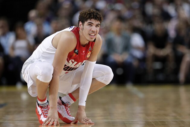 FILE-  In this Nov. 17, 2019, file photo, LaMelo Ball of the Illawarra Hawks squats during their game against the Sydney Kings in the Australian Basketball League in Sydney. The point guard from California who bypassed college and played overseas is expected to be one of the top picks when the twice-delayed NBA draft is held in November.  (AP Photo/Rick Rycroft, File)