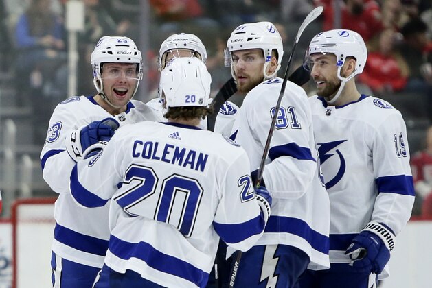 Tampa Bay Lightning center Carter Verhaeghe, left, celebrates with center Blake Coleman (20), defenseman Erik Cernak (81) and Barclay Goodrow after scoring against the Detroit Red Wings during the second period of an NHL hockey game Sunday, March 8, 2020, in Detroit. (AP Photo/Duane Burleson)