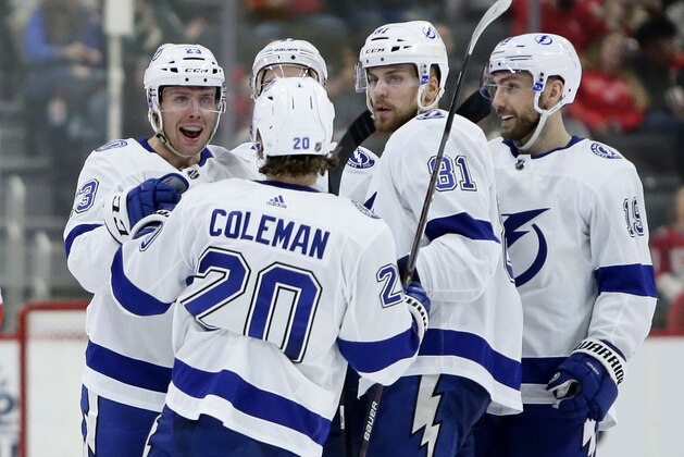 Tampa Bay Lightning center Carter Verhaeghe, left, celebrates with center Blake Coleman (20), defenseman Erik Cernak (81) and Barclay Goodrow after scoring against the Detroit Red Wings during the second period of an NHL hockey game Sunday, March 8, 2020, in Detroit. (AP Photo/Duane Burleson)