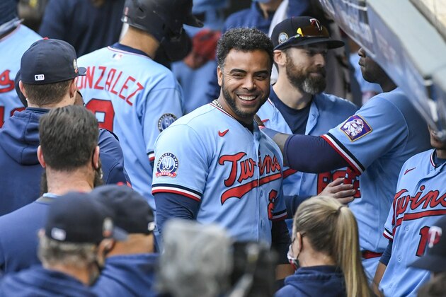 Minnesota Twins Minnesota Twins Nelson Cruz, center, smiles in the dugout after the Twins clinched the AL Central championship with the Chicago White Sox's loss during the tenth inning of a baseball game Sunday, Sept. 27, 2020, in Minneapolis. The Reds won 5-3. (AP Photo/Craig Lassig)