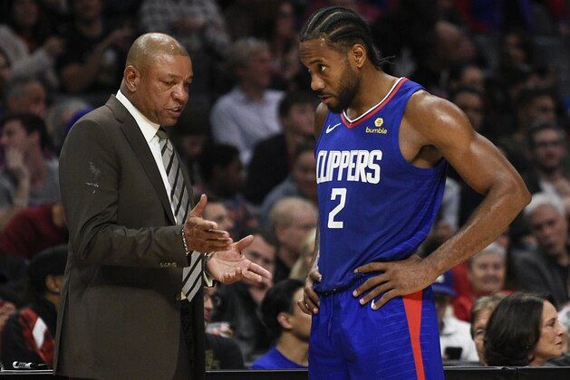 Los Angeles Clippers head coach Doc Rivers, left, talks with Kawhi Leonard during the second half of an NBA basketball game \against the New Orleans Pelicans in Los Angeles, Sunday, Nov. 24, 2019. The Clippers won 134-109. (AP Photo/Kelvin Kuo)