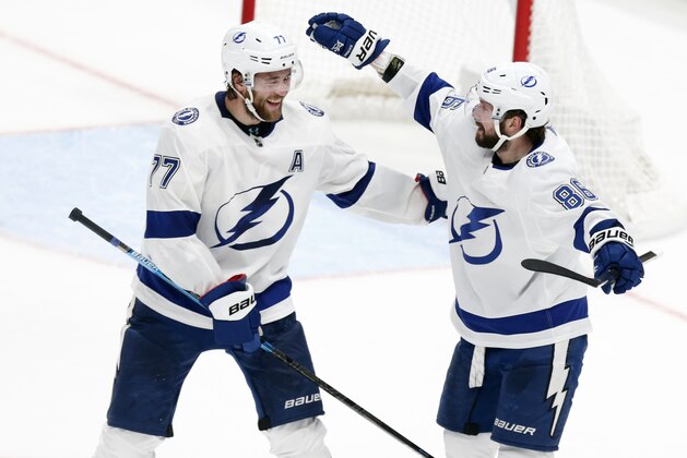 Tampa Bay Lightning forward Nikita Kucherov, right, of Russia, celebrates his game-winning goal against the Columbus Blue Jackets with teammate defenseman Victor Hedman, of Sweden, during overtime of an NHL hockey game in Columbus, Ohio, Monday, Feb. 10, 2020. The Lightning won 2-1. (AP Photo/Paul Vernon)