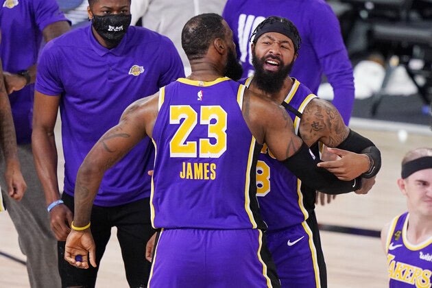 Los Angeles Lakers' LeBron James (23) celebrates with Markieff Morris (88) during a timeout in the second half of an NBA conference final playoff basketball game against the Denver Nuggets Saturday, Sept. 26, 2020, in Lake Buena Vista, Fla. The Lakers won 117-107 to win the series 4-1. (AP Photo/Mark J. Terrill)
