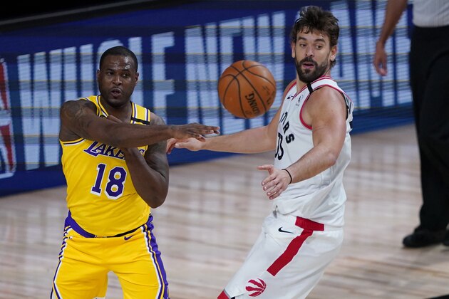 Los Angeles Lakers' Dion Waiters (18) passes around Toronto Raptors' Marc Gasol (33) during the second half of an NBA basketball game Saturday, Aug. 1, 2020, in Lake Buena Vista, Fla. (AP Photo/Ashley Landis, Pool)