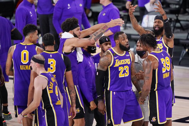 Los Angeles Lakers' LeBron James (23) talks with Dwight Howard (39) during a timeout in the second half of an NBA conference final playoff basketball game against the Denver Nuggets Saturday, Sept. 26, 2020, in Lake Buena Vista, Fla. The Lakers won 117-107 to win the series 4-1.(AP Photo/Mark J. Terrill)