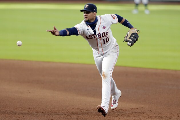 Houston Astros first baseman Yuli Gurriel (10) flips the ball to first base after fielding a hit during a baseball game against the Seattle Mariners Sunday, Aug. 16, 2020, in Houston. (AP Photo/Michael Wyke) Houston Astros first baseman Yuli Gurriel (10) flips the ball to first base after fielding a hit during a baseball game against the Seattle Mariners Sunday, Aug. 16, 2020, in Houston. (AP Photo/Michael Wyke)