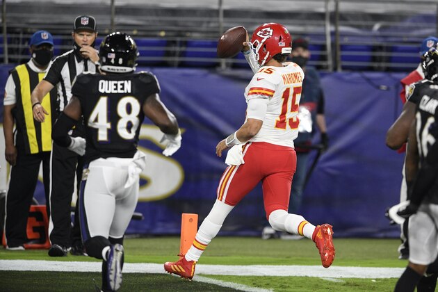 Kansas City Chiefs quarterback Patrick Mahomes (15) runs for a touchdown in front of Baltimore Ravens inside linebacker Patrick Queen (48) during the first half of an NFL football game Monday, Sept. 28, 2020, in Baltimore. (AP Photo/Nick Wass)
