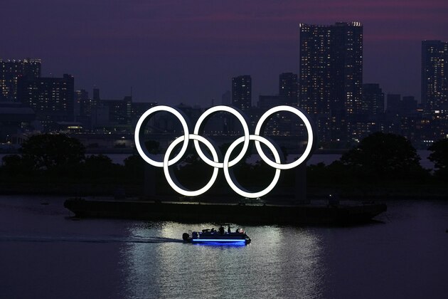 FILE - In this June 3, 2020, photo, the Olympic rings float in the water at sunset in the Odaiba section in Tokyo. The Tokyo Olympics are already the most expensive Summer Games on record with costs set to go higher, a wide-ranging study from Britain's University of Oxford indicates. This is even before the costs of the one-year delay from the COVID-19 pandemic are known with the cost overrun already at over 200%, lead author Bent Flyvbjerg explained in an interview with the Associated Press.  (AP Photo/Eugene Hoshiko, File)