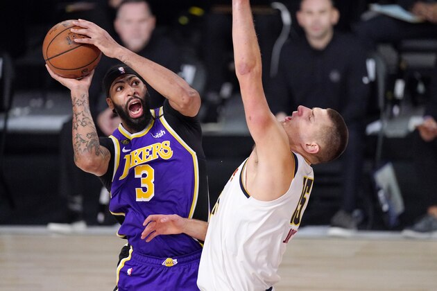 Los Angeles Lakers' Anthony Davis (3) drives against Denver Nuggets' Nikola Jokic (15) during the second half of an NBA conference final playoff basketball game Saturday, Sept. 26, 2020, in Lake Buena Vista, Fla. (AP Photo/Mark J. Terrill)