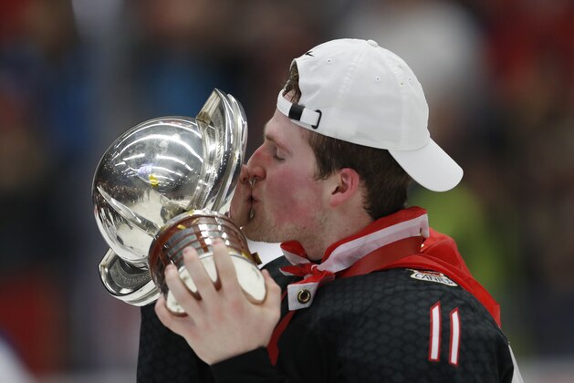 Canada's Alexis Lafreniere kisses the trophy after winning the U20 Ice Hockey Worlds gold medal match between Canada and Russia in Ostrava, Czech Republic, Sunday, Jan. 5, 2020. (AP Photo/Petr David Josek)
