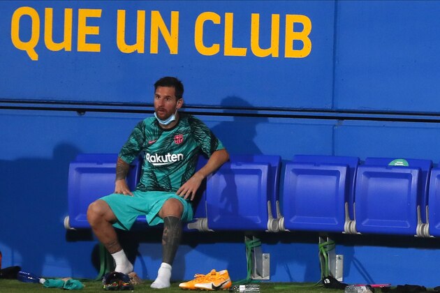 Barcelona's Lionel Messi sits on the bench during the pre-season friendly soccer match between Barcelona and Girona at the Johan Cruyff Stadium in Barcelona, Spain, Wednesday, Sept. 16, 2020. (AP Photo/Joan Monfort)