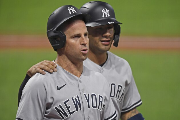 New York Yankees' Brett Gardner (11) walls to the dugout with Gleyber Torres after hitting a two run home run in the seventh inning of Game 1 of an American League wild-card baseball series against the Cleveland Indians, Tuesday, Sept. 29, 2020, in Cleveland. (AP Photo/David Dermer)