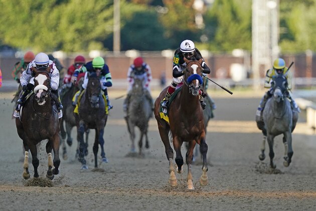 Jockey John Velazquez rides Authentic, second from right, as they cross the finish line to win the 146th running of the Kentucky Derby at Churchill Downs, Saturday, Sept. 5, 2020, in Louisville, Ky. (AP Photo/Mark Humphrey)
