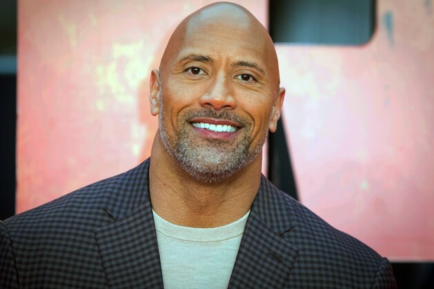 FILE - In this April 11, 2018 file photo, actor Dwayne Johnson poses for photographers at the premiere of the