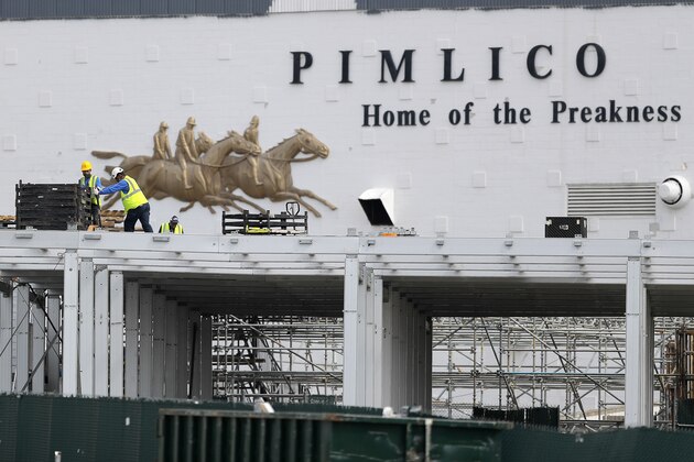 A crew works on putting up a platform near the main entrance at Pimlico Race Course, Friday, May 15, 2020, in Baltimore. Horse racing is in a state of transition at a time usually reserved for Triple Crown season. The Preakness would have been run Saturday, May 16, 2020, in Baltimore. But Pimlico Race Course and many tracks across North America remain dark because of the coronavirus pandemic. (AP Photo/Julio Cortez) A crew works on putting up a platform near the main entrance at Pimlico Race Course, Friday, May 15, 2020, in Baltimore. Horse racing is in a state of transition at a time usually reserved for Triple Crown season. The Preakness would have been run Saturday, May 16, 2020, in Baltimore. But Pimlico Race Course and many tracks across North America remain dark because of the coronavirus pandemic. (AP Photo/Julio Cortez)